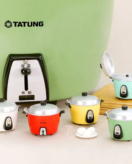 A set of miniature TATUNG toy rice cookers in various colors including white, red, yellow, mint green, and light blue, displayed alongside a matching green background piece and accessories.