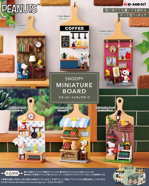 Snoopy miniature boards with various scenes on a display stand.